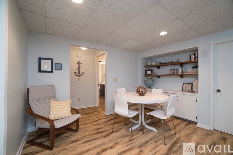 A dining area with a white table and chairs.