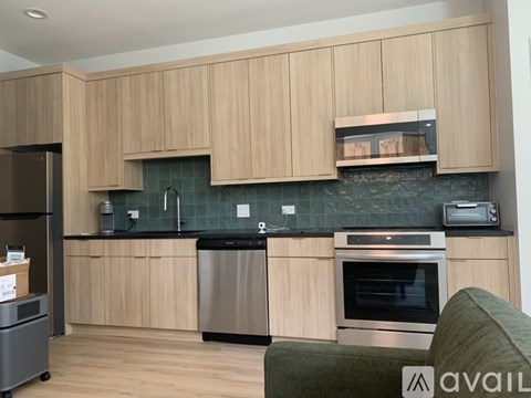 A modern kitchen with wooden cabinets and stainless steel appliances.