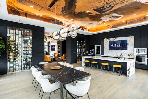 A modern dining area with a long table and chairs.