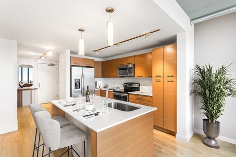 A modern kitchen with a dining table and chairs.