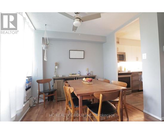 A dining room with a wooden table and chairs.