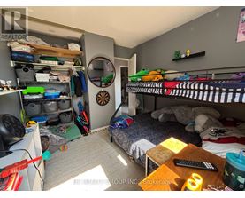 A small bedroom with a bed, a desk, and a bunk bed.