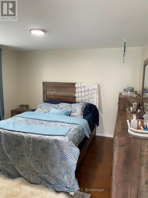 A bedroom with a bed covered in a blue and white patterned duvet.