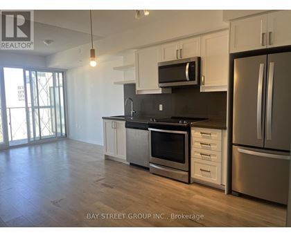 A kitchen with white cabinets and stainless steel appliances.