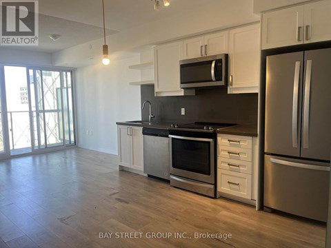 A kitchen with white cabinets and stainless steel appliances.