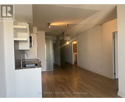 A kitchen with white cabinets and a sink.