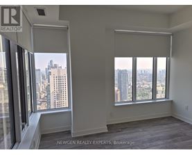A room with a view of the cityscape through large windows.