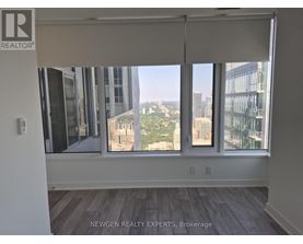 A room with a view of the cityscape through the windows.