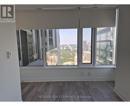 A room with a view of the cityscape through the windows.