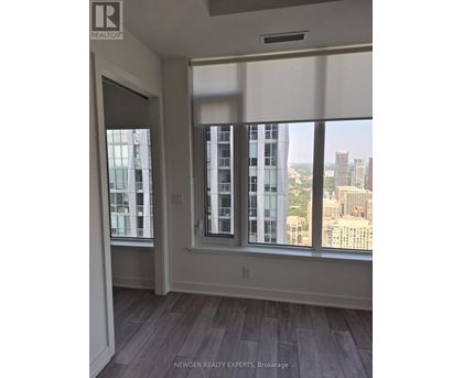 A room with a view of the city through large windows.