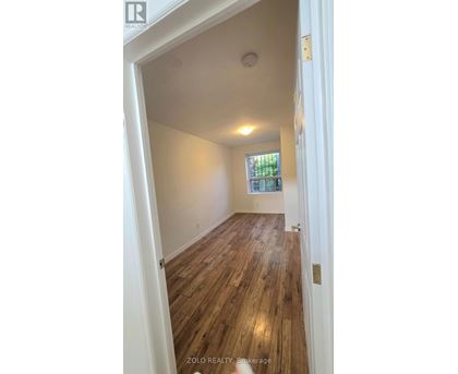 A room with wooden floors and a window.