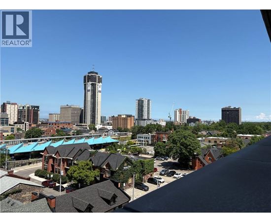 A cityscape with a clear blue sky and buildings of various heights.