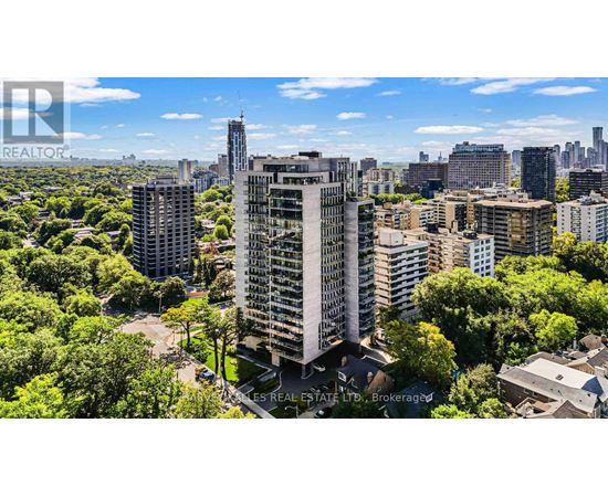 A cityscape with a mix of residential and commercial buildings, with a clear blue sky above.