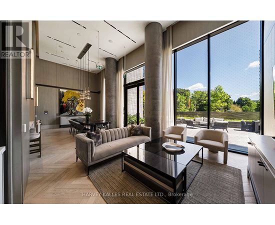 A modern living room with a glass table and a large window.
