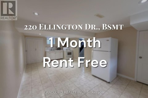 A room with a white fridge and a sign that says 1 month rent free.