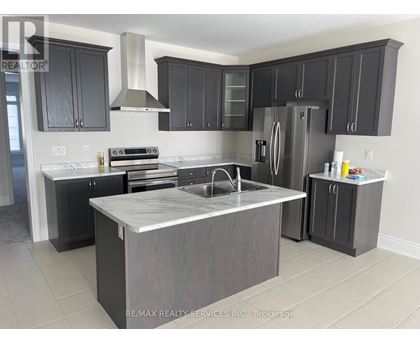 A modern kitchen with dark grey cabinets and a central island.