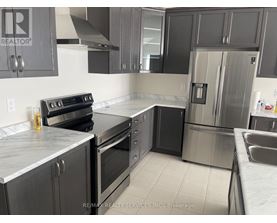 A kitchen with a stove, oven, and refrigerator.