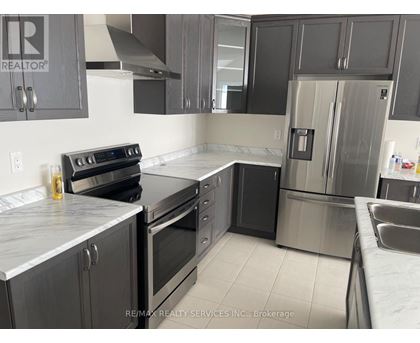 A kitchen with a stove, oven, and refrigerator.