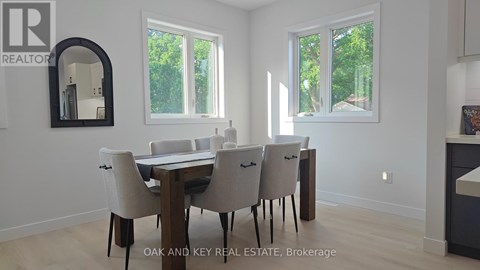 A dining room with a table and chairs.