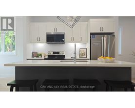A kitchen with white cabinets and a black countertop.