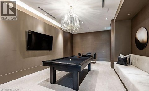 A modern living room with a pool table and a television.