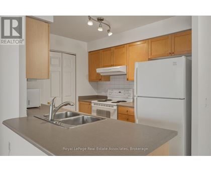 A kitchen with a sink and a refrigerator.
