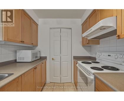 A white door is in the middle of a kitchen.