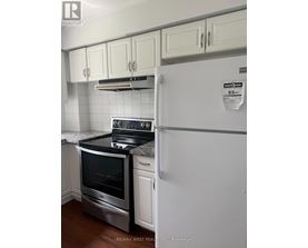 A white fridge with a sticker on it in a kitchen.
