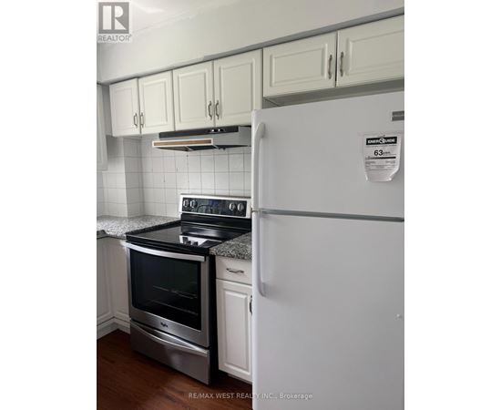 A white fridge with a sticker on it in a kitchen.
