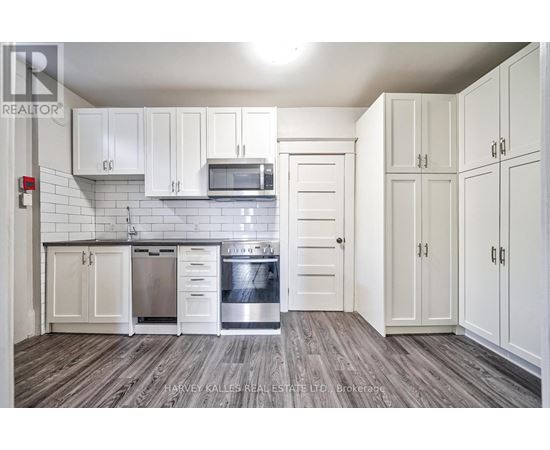 A kitchen with white cabinets and a stainless steel dishwasher.