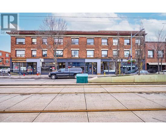 A street view of a building with a car parked in front.