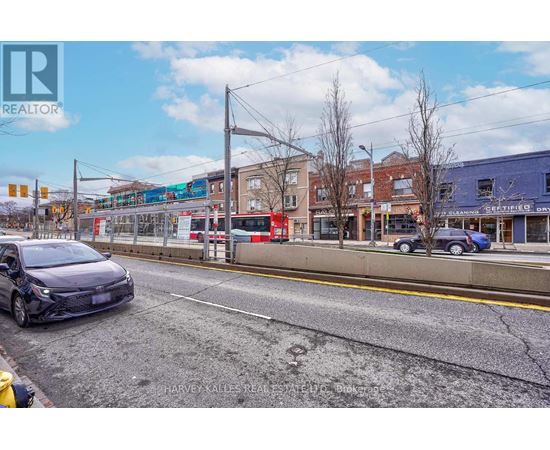 A street view with a car parked on the side of the road.