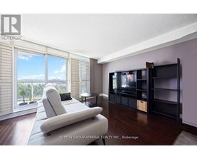 A living room with a large couch and a television.