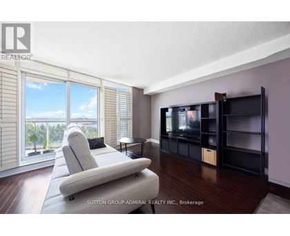 A living room with a large couch and a television.