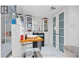 A kitchen with white cabinets and a wooden countertop.