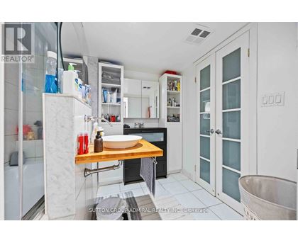 A kitchen with white cabinets and a wooden countertop.