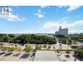 A brokerage office is located in a large open plaza with a river and buildings in the background.
