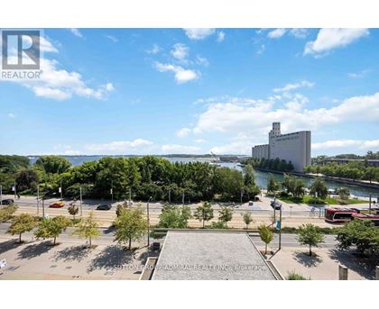 A brokerage office is located in a large open plaza with a river and buildings in the background.