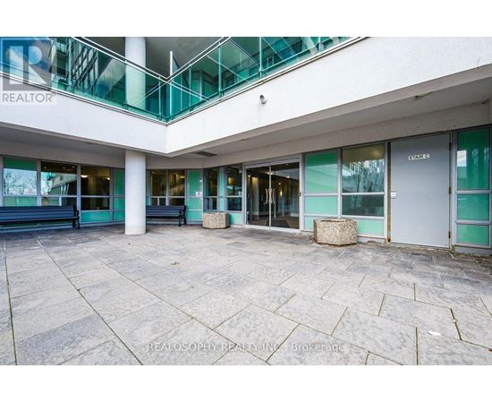A large open space with a glass balcony and a sign that says REALTOR.