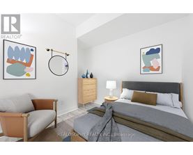 A bedroom with a bed, a chair, and a nightstand.