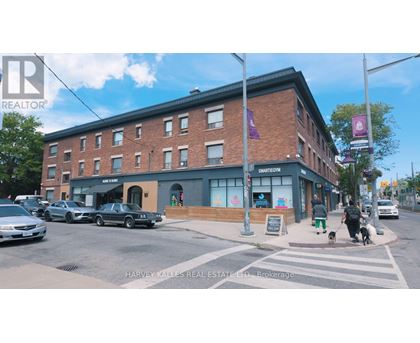 A street view of a building with a sign that reads "HARVEY KATLES REAL ESTATE LTD."