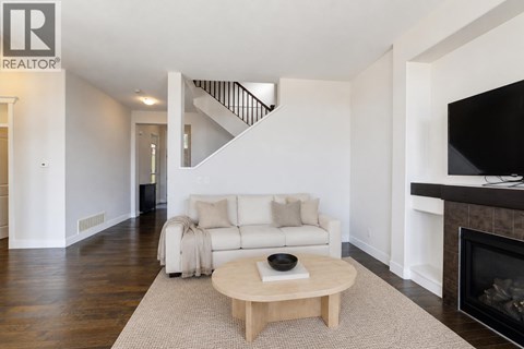 A living room with a white couch and a coffee table.
