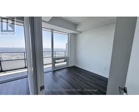 A room with a view of the ocean through large windows.