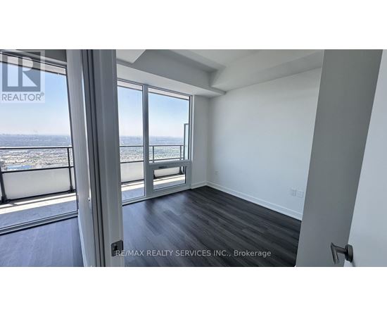 A room with a view of the ocean through large windows.