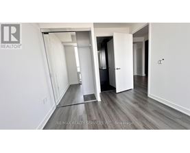 A room with a white wall and a wooden floor.
