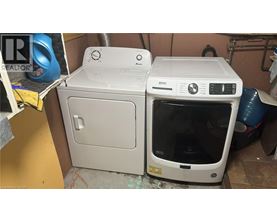 A white dishwasher and oven are placed next to each other in a room.