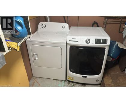 A white dishwasher and oven are placed next to each other in a room.