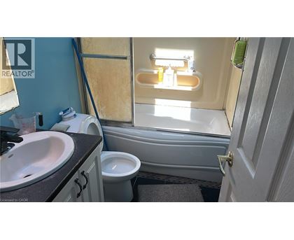 A bathroom with a sink, toilet and bathtub.