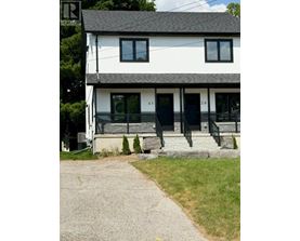 A white house with black shutters and a black door.