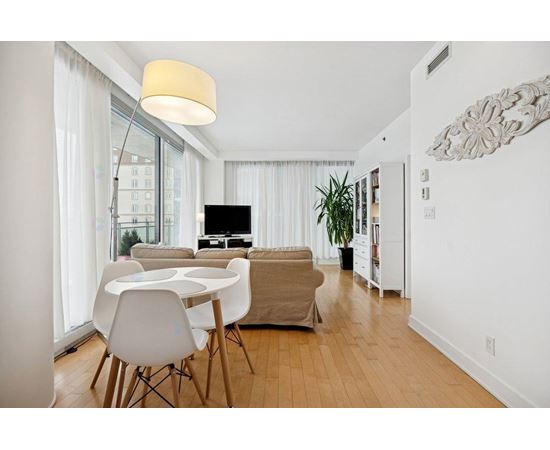 A modern living room with a white table and chairs.